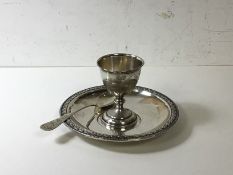 A continental child's egg cup, saucer and spoon, marked 800, saucer inscribed Gabriele, egg cup