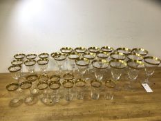 A set of stemware drinking glasses and tumblers, all with gilt rims with floral decoration,