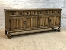 A dry oak sideboard of 17th century design, the rectangular top over four drawers and two twin