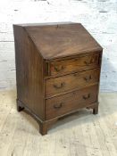 A small early 20th centruy mahogany bureau, the fall front revealing fitted interior, over three