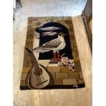 A 20th century tapestry wall hanging depicting bird in window with grapes and lute, initialled AD to