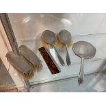 A 1940's 50's vanity set including comb, hand mirror, two silver clothes brushes and two silver hair