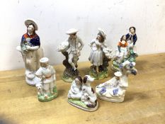 A group of Staffordshire figures including man and woman with baskets, courting couple, (12cm h) etc