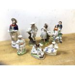 A group of Staffordshire figures including man and woman with baskets, courting couple, (12cm h) etc