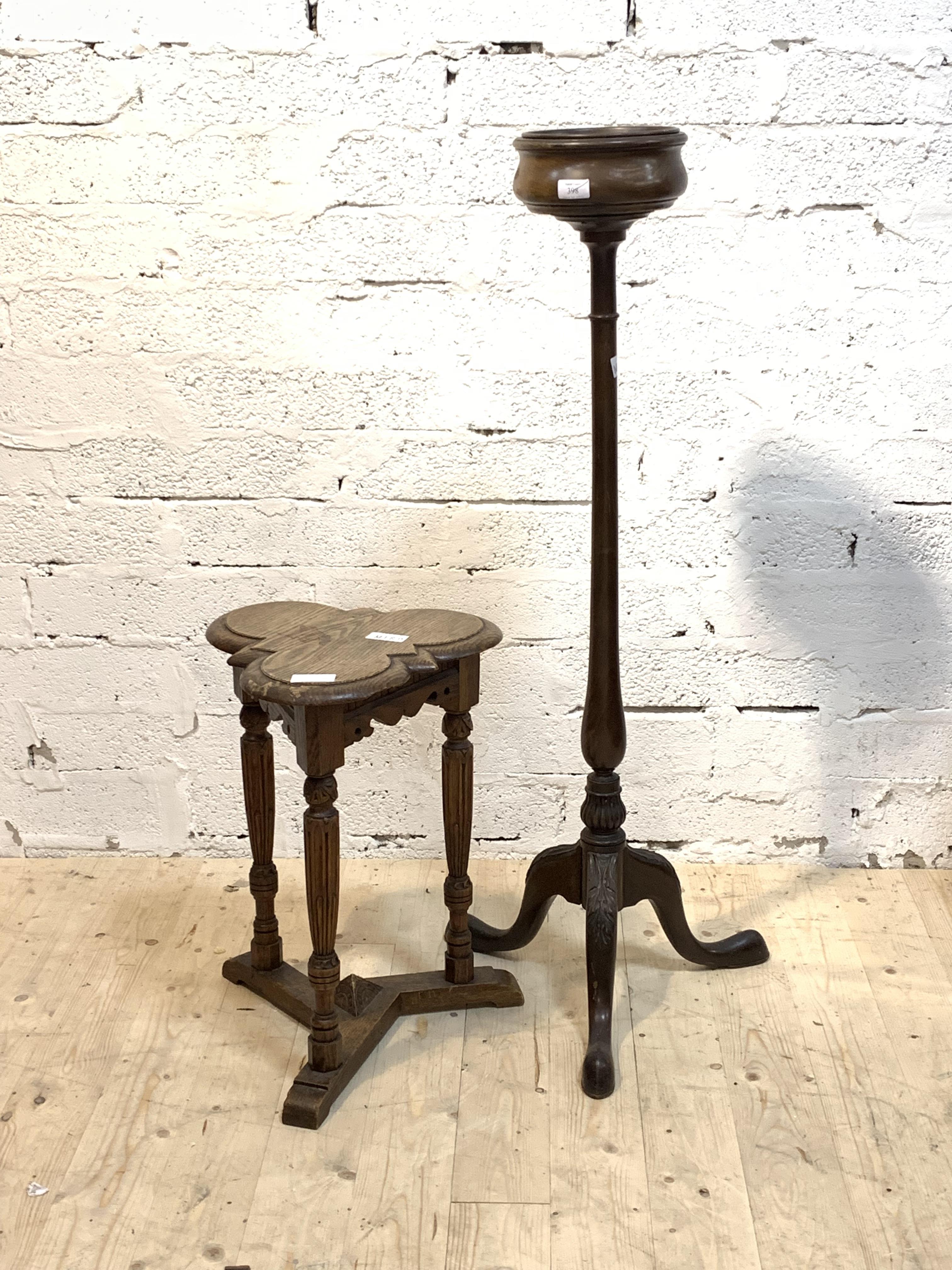 An oak occasional table, early 20th century, with a trefoil top over turned and fluted supports
