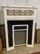 A late 19th early 20thc fire surround, the white painted iron with five floral tiles to frieze