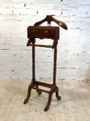 A hardwood dumb valet stand, with two drawers, spiral turned supports and arched sledge feet,