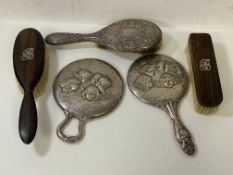 A silver hand mirror, Sheffield 1907, with five putti verso, (19cm x 14cm) and similar decorated