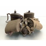 British water bottles, one WWI style with leather fitting, three WWII paten bottles and another