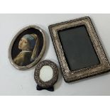 A silver photo frame, hallmark rubbed, (internal 13cm x 8.5cm), a circular photo frame and a white