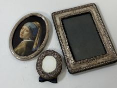 A silver photo frame, hallmark rubbed, (internal 13cm x 8.5cm), a circular photo frame and a white