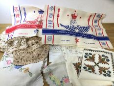 A quantity of linens including embroidered table cloths, doilies, place mats, table runner etc and