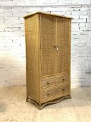 A split cane and basketwork wardrobe, circa 1970's, the two doors enclosing interior fitted for