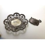 An Indian white metal footed tray, the pierced edge with foliate design with oval well with beaded