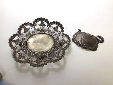 An Indian white metal footed tray, the pierced edge with foliate design with oval well with beaded