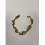 A ladies gold bracelet marked 9k with six leaf shaped panels, weighs 12.33 grammes (18cm when open)