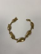 A ladies gold bracelet marked 9k with six leaf shaped panels, weighs 12.33 grammes (18cm when open)