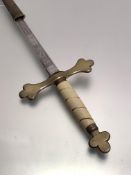 A brass hilted masonic sword with faux ivory handle, etched blade, leather scabbard with brass