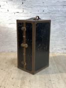 A 1920s steamer trunk wardrobe, the riveted metal bound trunk with domed top and leather carry