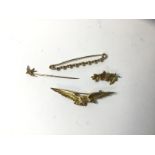 A brooch marked 9ct in the form of a bird, a brooch marked 10k in the form of three maple leaves,