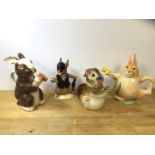 A group of four china novelty teapots, in the form of rabbits, including a Royal Doulton Bunnykins