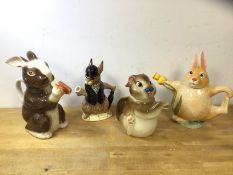 A group of four china novelty teapots, in the form of rabbits, including a Royal Doulton Bunnykins
