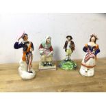 A group of Staffordshire figures including old woman pouring from jug into cup, (16cm h), a courting