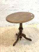 A 19th century mahogany snap top table, the oval top with moulded edge over turned column and triple