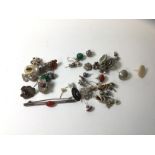 A collection of stud earrings including carnelian, amber, and silver, a carnelian bar brooch etc (