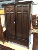 A 1920's / 30's wardrobe with moulded cornice over two panelled doors with two separate hanging