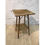 A cane and wicker occasional table the square top on supports united by undertier, (67cm x 42cm x