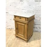 A Victorian bedside cabinet with marble top over single frieze drawer and panelled cupboard space