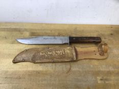A bowie knife, blade marked Original Bowie Knife Atlanta Foreign, with leather cover marked Made