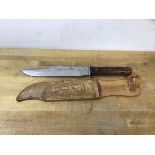 A bowie knife, blade marked Original Bowie Knife Atlanta Foreign, with leather cover marked Made