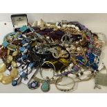 A large quantity of costume jewellery including necklaces, bangles, cufflinks etc, also a