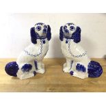 A pair of blue and white Staffordshire chimney spaniels (26cm h)