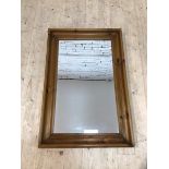 A modern rectangular wall mirror the bevelled glass within a convetto moulded pine frame, (90cm x