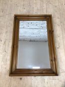 A modern rectangular wall mirror the bevelled glass within a convetto moulded pine frame, (90cm x