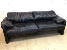 A two seater Maralunga black leather sofa with Cassina label, (73cm h x 192cm x 85cm)