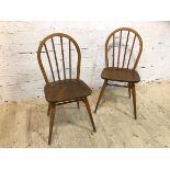 A pair of Ercol side chairs, hoop and spindle back, beech and elm, (86cm x 40cm x39cm)