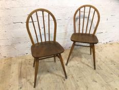A pair of Ercol side chairs, hoop and spindle back, beech and elm, (86cm x 40cm x39cm)