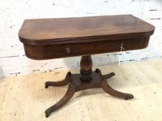 A Late Regency mahogany tea table, the fold over revolving top over frieze with faux drawer and