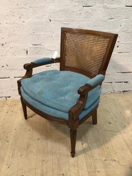 A Georgian inspired library armchair with cane back scrolled padded arms, buttoned seat cushion on