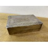 An Eastern white metal cigarette box with engraved decoration to top and Arabic inscription to base,