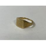 A 9ct gold signet style ring with engraving to shoulders, size V, weighs 2.44 grammes