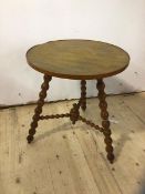 A 1930's 40's oak cricket style table the circular top on three splayed bobbin turned supports