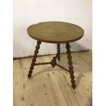 A 1930's 40's oak cricket style table the circular top on three splayed bobbin turned supports