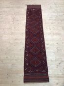 A Mashwani runner with six diamonds to field within geometric border and overall motif, (275cm x