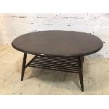 An Ercol coffee table the ovoid top over spindle lower tier on turned splayed supports (44cm x 100cm