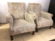 A pair of 1920's / 30's upholstered scroll back easy chairs, each raised on cabriole front supports,